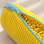 Close-up of the yellow EnthiraGlow shoe-washing bag, showing the pale aqua zip, cover tab and soft tufted lining.