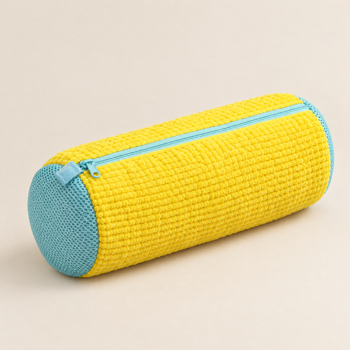 Yellow EnthiraGlow shoe-washing bag with a ribbed exterior, closed pale aqua zip and mesh end panels on an ivory background.